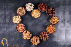 assorted nuts dried fruits heart shaped mini different bowls with pecan pistachios almond peanut top view