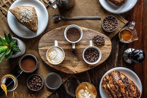 high angle shot coffee beans jars breakfast table with some pastry